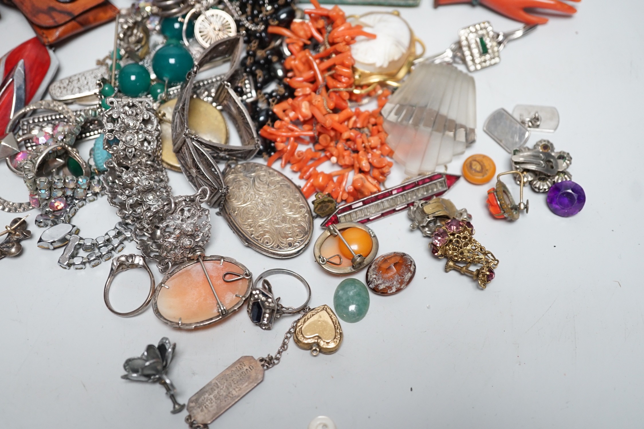 Assorted costume jewellery and other items including a silver belt buckle and enamelled egg pendant.